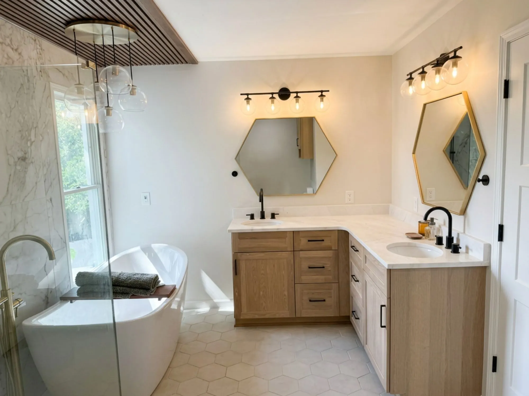 Primary bathroom remodel in Briarcliff, MO with freestanding tub and hexagon marble surround Primary bathroom remodel in Briarcliff, MO with freestanding tub and hexagon marble surround